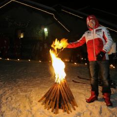 Nicky helps prepare the skiers for the torchlit run down the mountain. - Photo: Courtesy Ducati