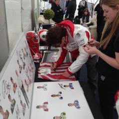 Nicky signing memorabilia before taking to the stage for Riders for Health's Day of Champions auction. - Photo: CJ